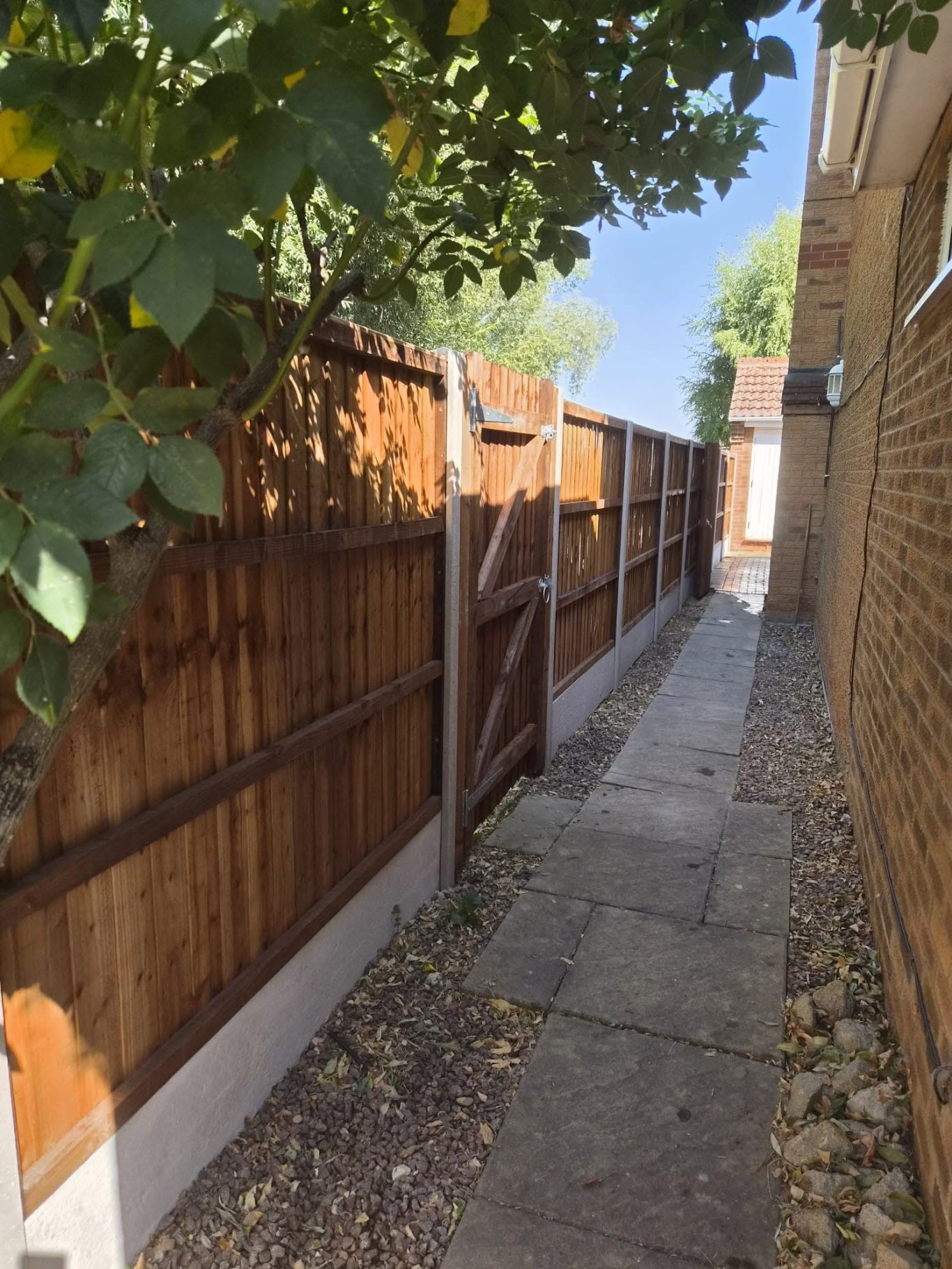 Boundary fencing with custom gate in Peterborough Boundary fencing with recessed concrete posts, gravel boards, pressure treated panels and a custom made gate installed in Peterborough